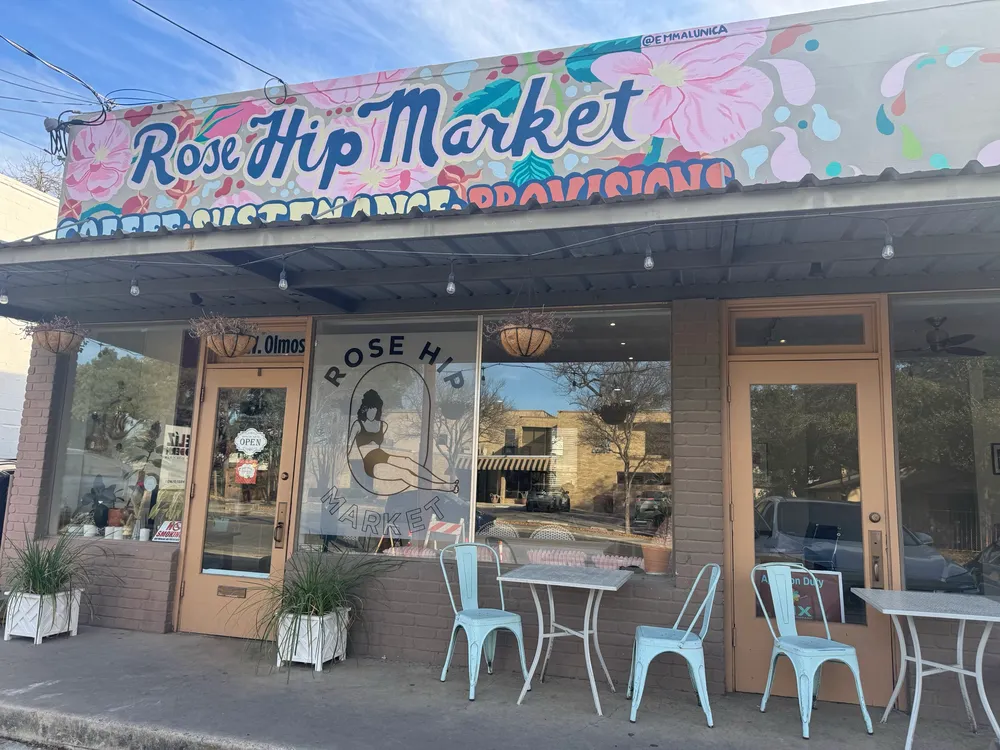The Rose Hip Market storefront on West Olmos Drive, under its painted floral sign